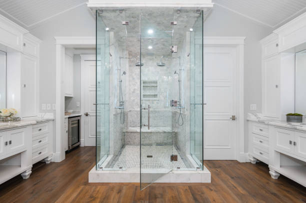 Pristine glass shower doors in a polished bathroom, illustrating the success of effective cleaning tips.